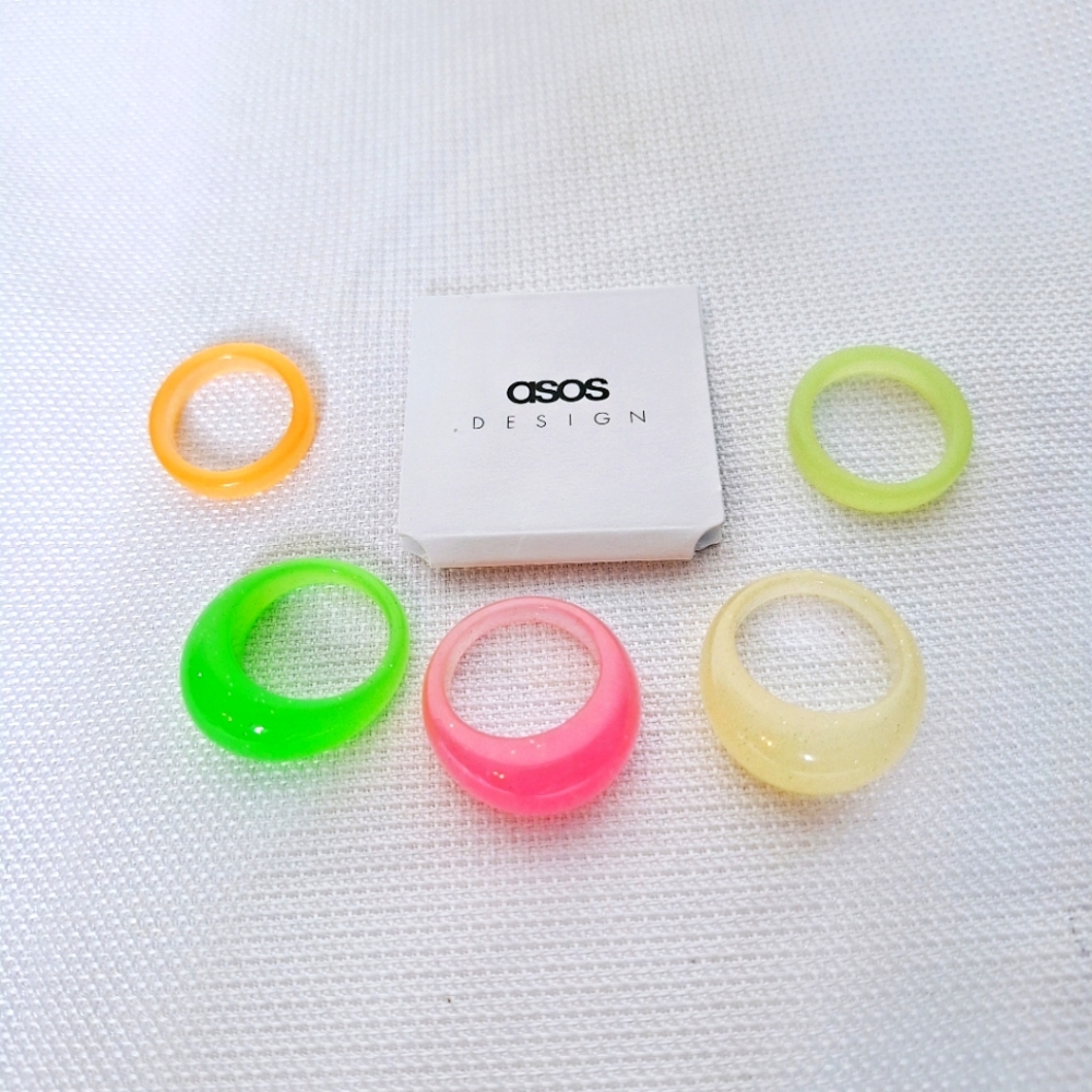 ASOS Brand "Glowing With Pride" Neon glow In the dark ring set.